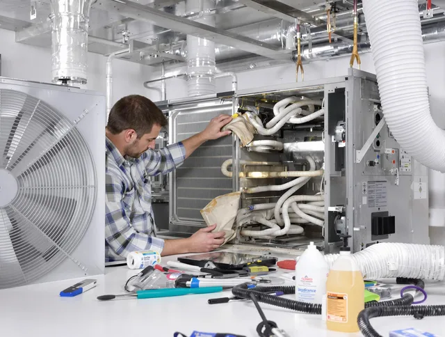 Kingston Air Duct Cleaning specialist performing precision AC coil cleaning in Kingston