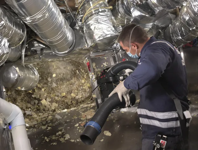 Kingston Air Duct Cleaning specialist operating negative pressure cleaning equipment for thorough duct maintenance in Kingston